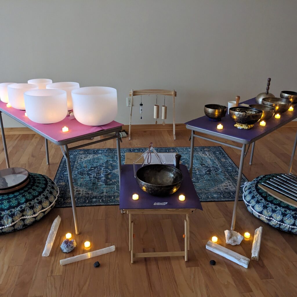 Sound bath journey set up with crystal bowls and Tibetan bowls, crystals, and chimes, with Sound Healing Therapy with Lara