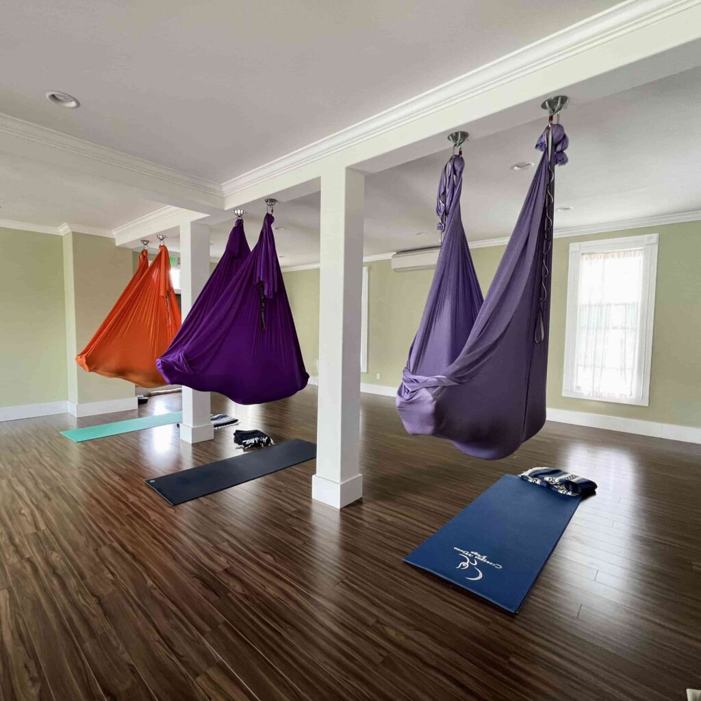 Guests relax in three hammocks during a sound bath in La Conner at the Crescent Moon Yoga Studio.