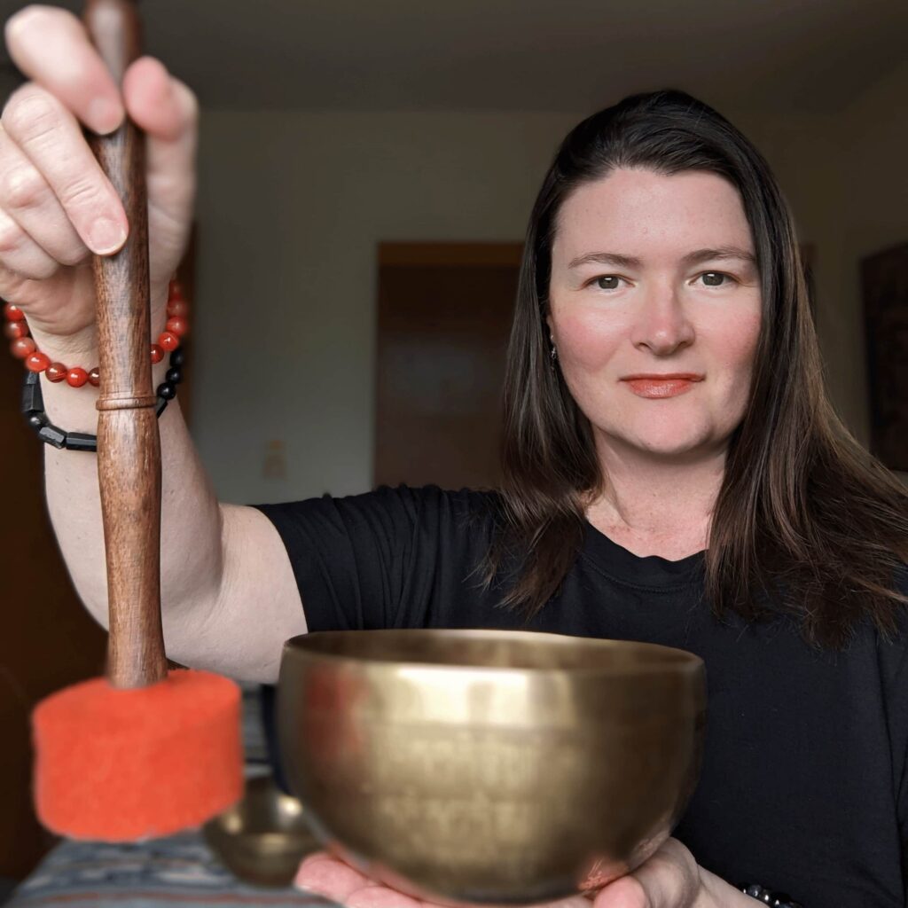 Sound healing practitioner Lara Dunning working with a Tibetan singing bowl demonstrating nervous system regulation through vibrational sound therapy